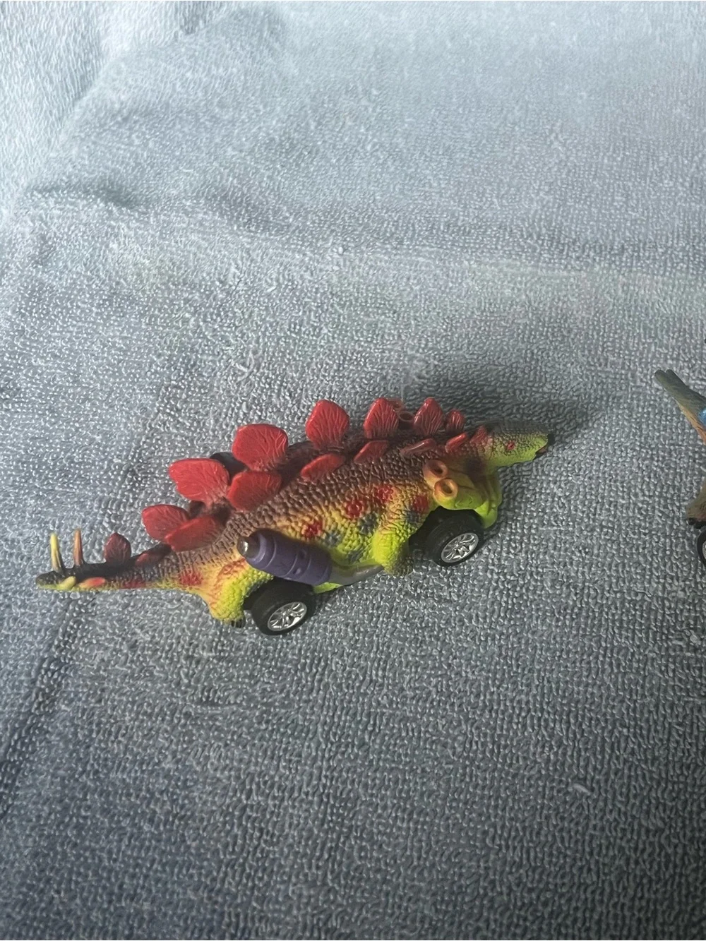 Two dinosaur pull-back toy cars
